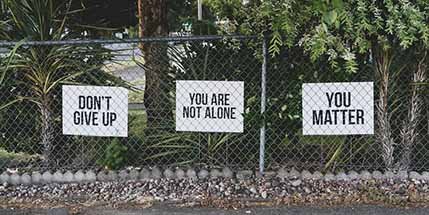 don't give up. You are not alone, you matter signage on metal fence